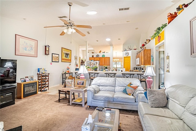 living room featuring high vaulted ceiling, light carpet, ceiling fan, and visible vents