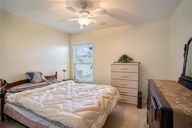 bedroom featuring a textured ceiling, carpet floors, and a ceiling fan