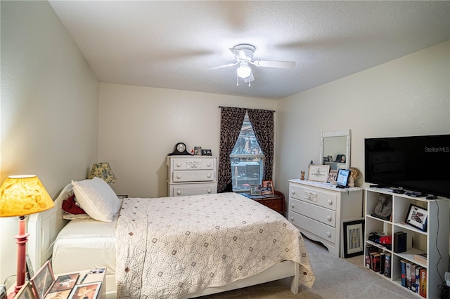 bedroom with carpet, ceiling fan, and a textured ceiling