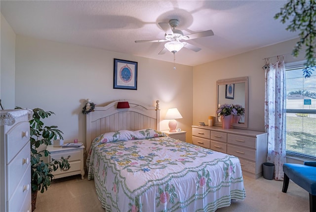 bedroom featuring a ceiling fan and light carpet