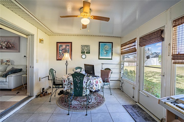 sunroom featuring ceiling fan