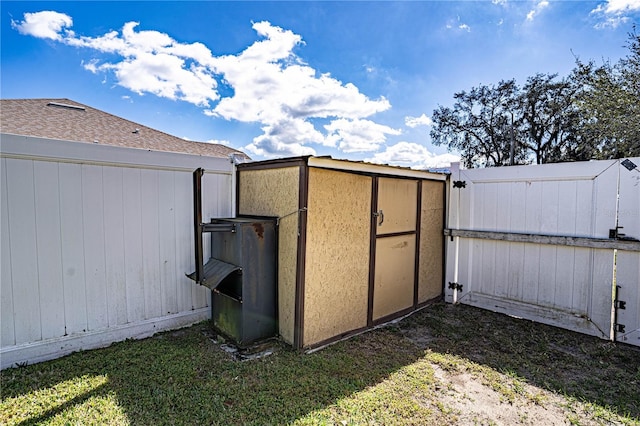 view of outbuilding featuring a gate and fence