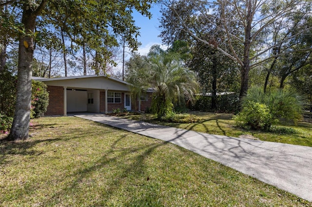 view of front of property with a carport, concrete driveway, brick siding, and a front yard