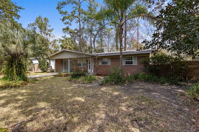 ranch-style house featuring brick siding and a front lawn