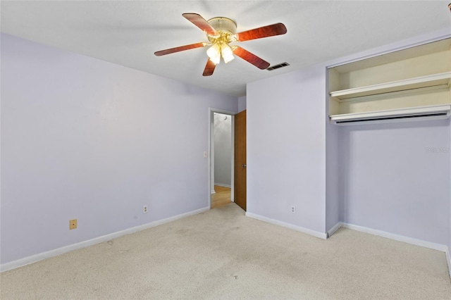 unfurnished bedroom with a ceiling fan, carpet, visible vents, and baseboards