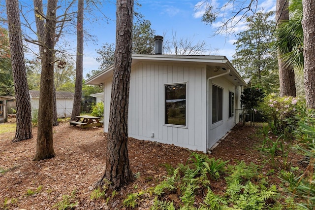 view of side of home featuring fence