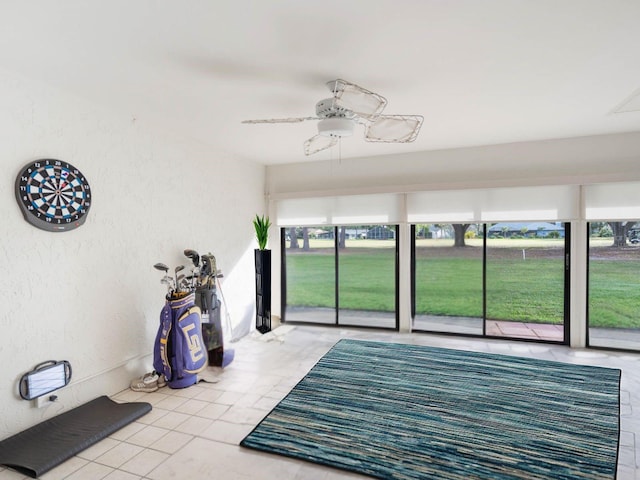 sunroom featuring a ceiling fan