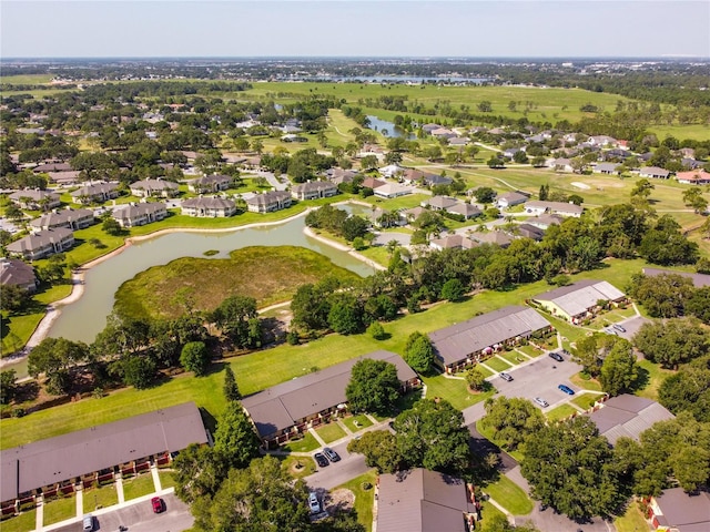 drone / aerial view with a residential view and a water view