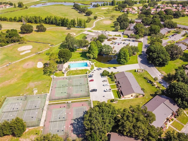 drone / aerial view with a water view, view of golf course, and a residential view