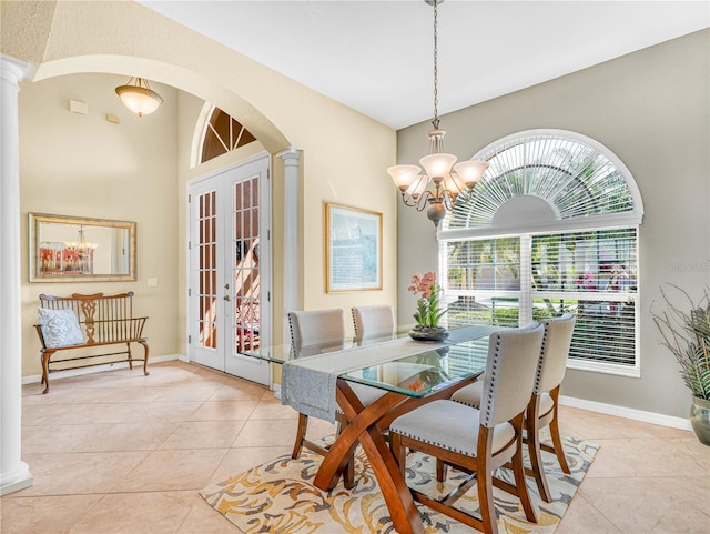 dining area featuring light tile patterned floors, arched walkways, french doors, ornate columns, and a chandelier