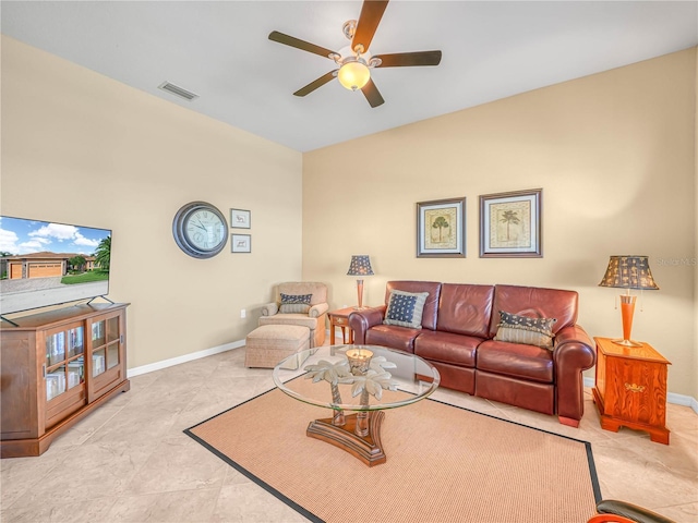 living room with ceiling fan, visible vents, and baseboards