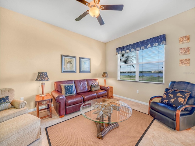 living room with ceiling fan and baseboards