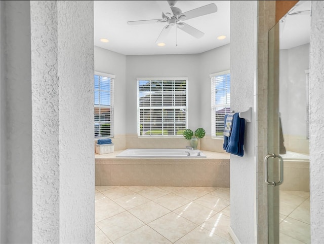 full bath with a ceiling fan, a stall shower, a bath, and tile patterned floors