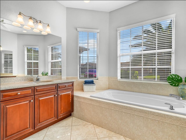 bathroom with a wealth of natural light, tile patterned flooring, and a garden tub