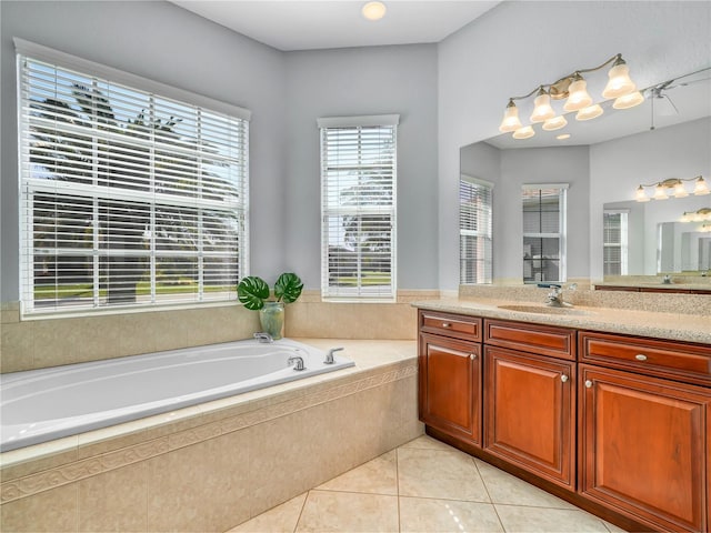 bathroom featuring a garden tub, tile patterned flooring, and vanity