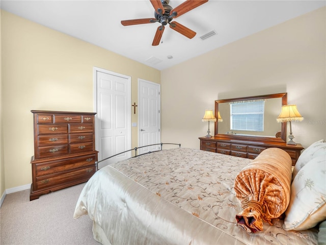 carpeted bedroom featuring a ceiling fan, a closet, visible vents, and baseboards