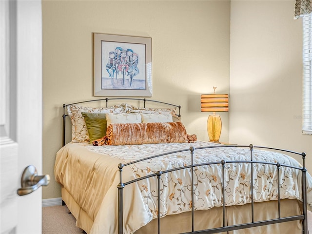 bedroom with baseboards and carpet flooring