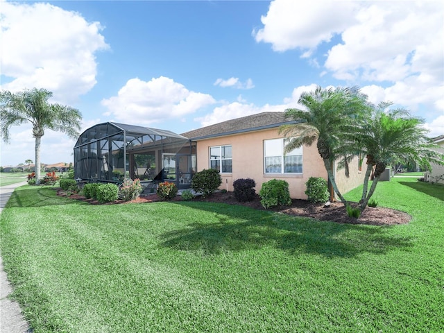 view of front of property with glass enclosure, a front lawn, and stucco siding