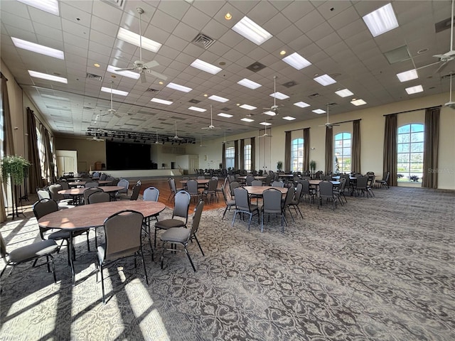 dining room featuring ceiling fan, carpet floors, a paneled ceiling, and visible vents