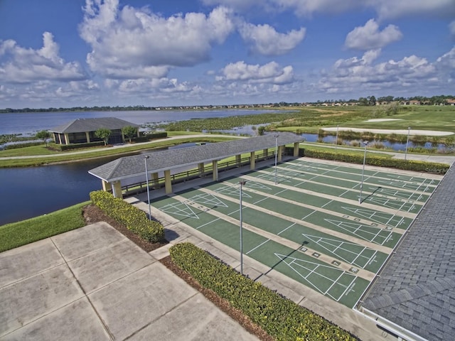 view of home's community with shuffleboard and a water view