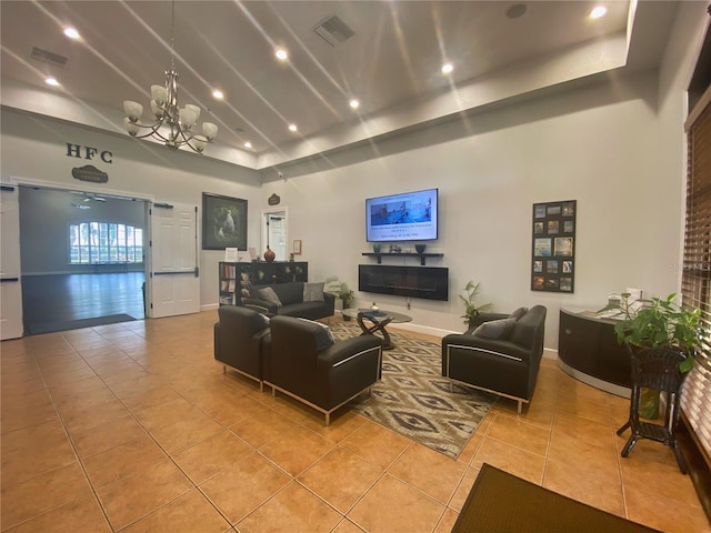 living area with a chandelier, visible vents, high vaulted ceiling, and light tile patterned floors