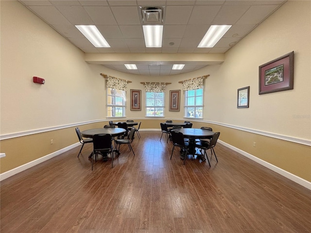 dining space with wood finished floors and baseboards