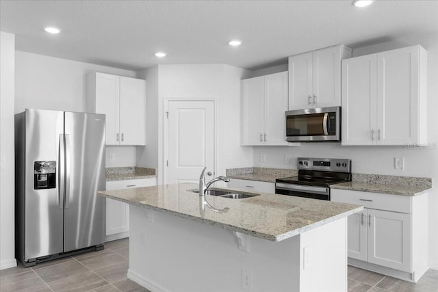 kitchen with an island with sink, white cabinetry, appliances with stainless steel finishes, and a sink