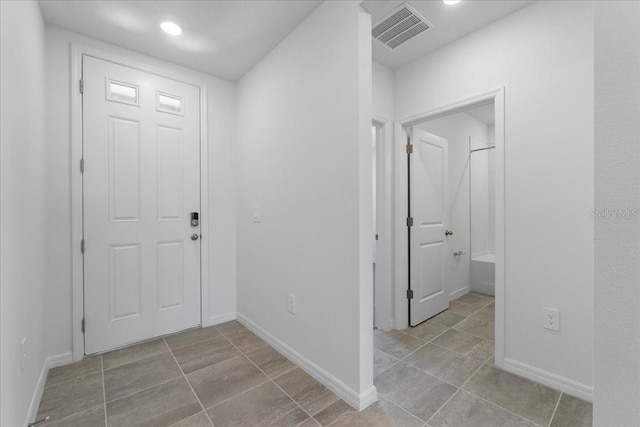 tiled foyer featuring baseboards, visible vents, and recessed lighting