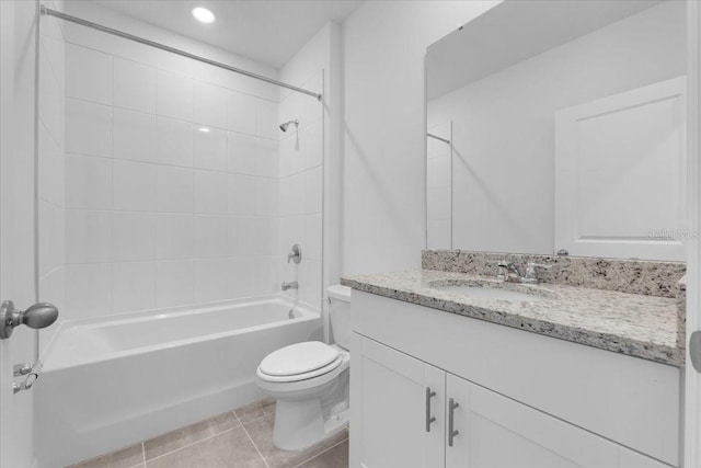 bathroom with toilet, vanity,  shower combination, and tile patterned floors