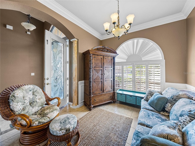 living area with arched walkways, crown molding, decorative columns, light tile patterned floors, and an inviting chandelier