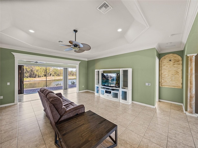 living area with visible vents, a raised ceiling, crown molding, and light tile patterned flooring