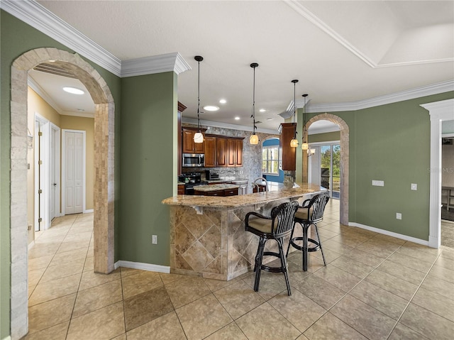 kitchen featuring arched walkways, black electric range, stainless steel microwave, and light stone countertops