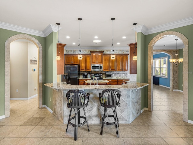 kitchen with arched walkways, stainless steel microwave, brown cabinets, a peninsula, and black refrigerator with ice dispenser