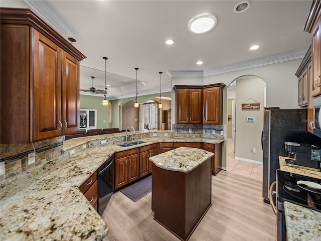 kitchen featuring arched walkways, light stone counters, a sink, dishwasher, and tasteful backsplash