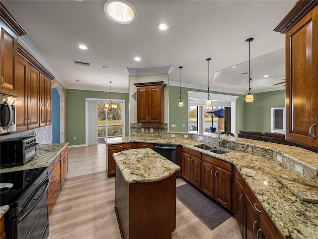 kitchen featuring crown molding, appliances with stainless steel finishes, a sink, and tasteful backsplash