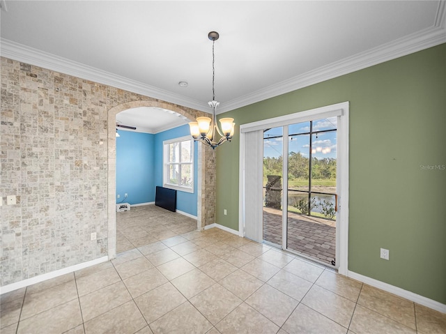 unfurnished room featuring arched walkways, crown molding, baseboards, and light tile patterned floors