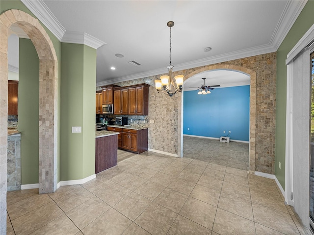 kitchen with arched walkways, stainless steel microwave, crown molding, and light tile patterned floors