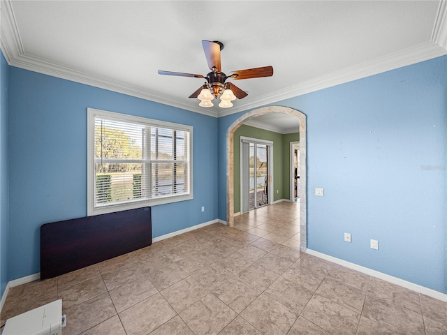 unfurnished room featuring arched walkways, ceiling fan, ornamental molding, and baseboards