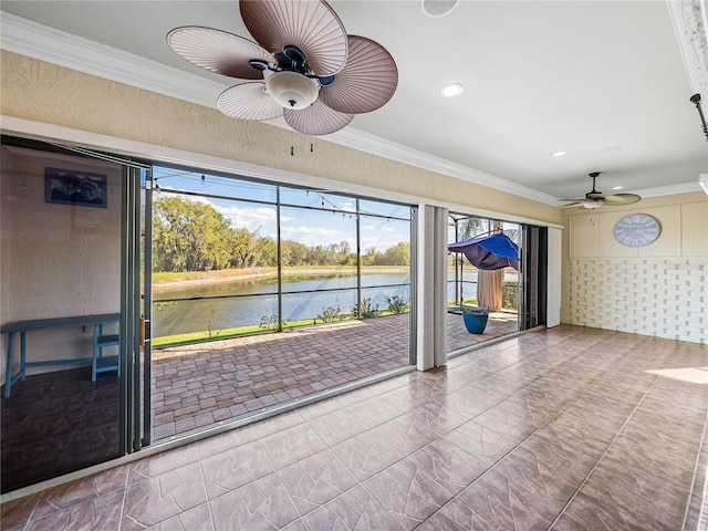 interior space with ornamental molding, a water view, a ceiling fan, and recessed lighting