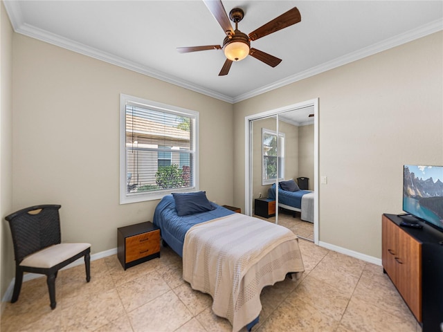 bedroom featuring baseboards, ceiling fan, a closet, and crown molding