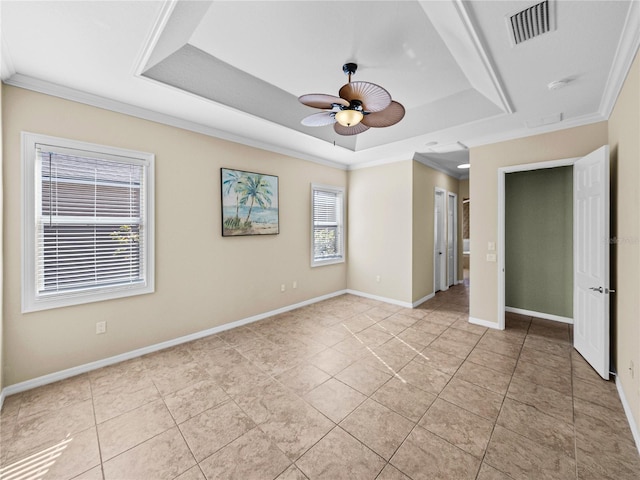 unfurnished bedroom with baseboards, a raised ceiling, visible vents, and crown molding