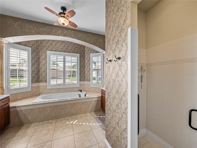 bathroom featuring ceiling fan, a shower stall, a bath, tile patterned floors, and wallpapered walls