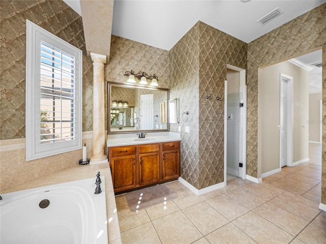 full bath with a garden tub, tile patterned flooring, vanity, visible vents, and decorative columns