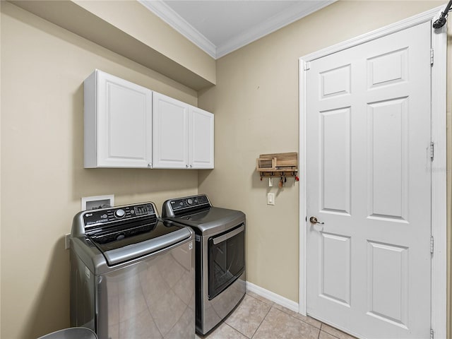 washroom with cabinet space, light tile patterned floors, baseboards, ornamental molding, and separate washer and dryer