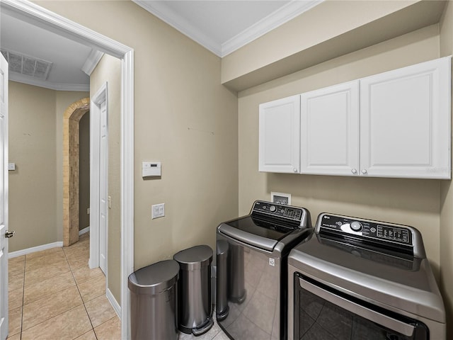 clothes washing area featuring crown molding, visible vents, cabinet space, light tile patterned flooring, and washer and dryer