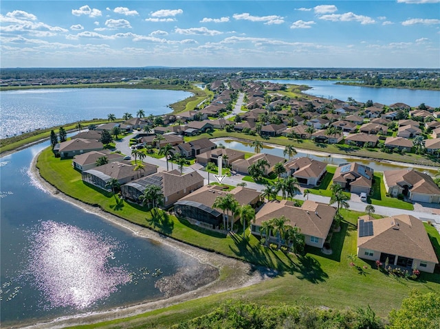 drone / aerial view with a water view and a residential view