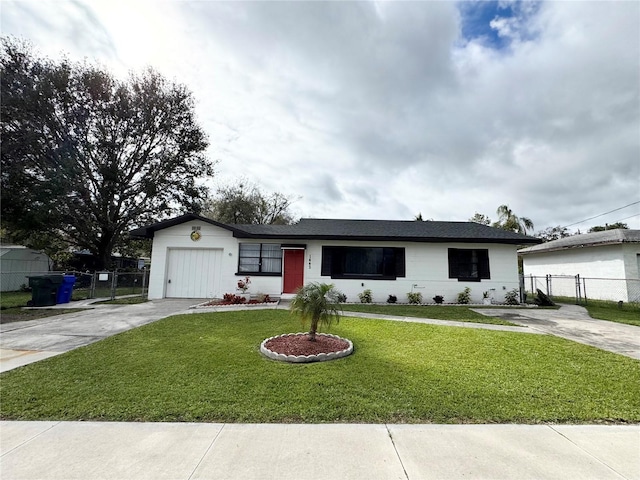 ranch-style house with a garage, driveway, a front lawn, and fence