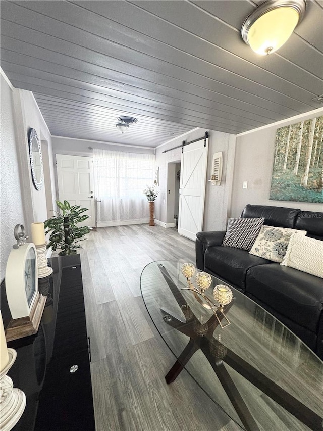 living room with wood finished floors, wooden ceiling, and a barn door