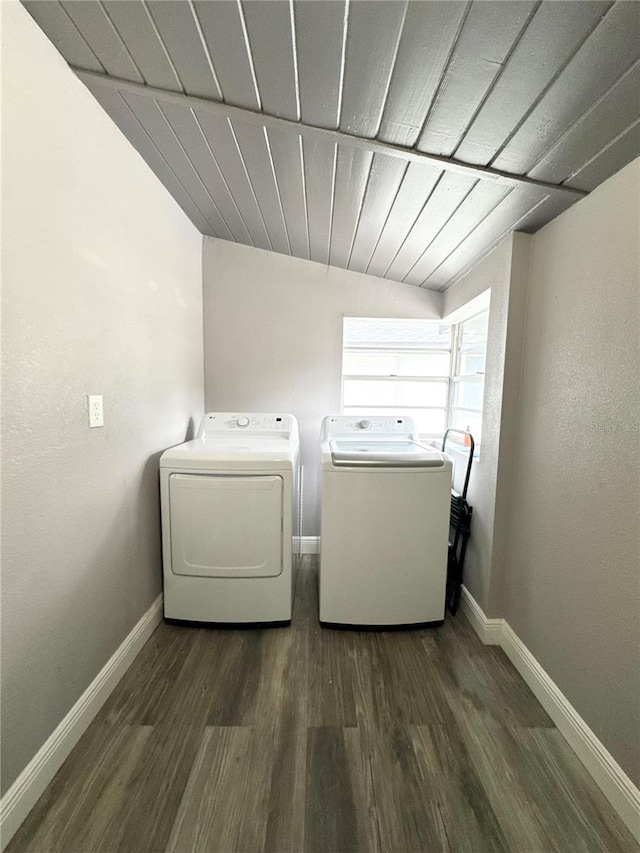 laundry room featuring laundry area, baseboards, wooden ceiling, wood finished floors, and separate washer and dryer