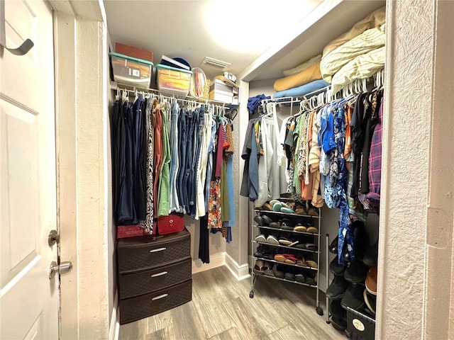 spacious closet featuring wood finished floors